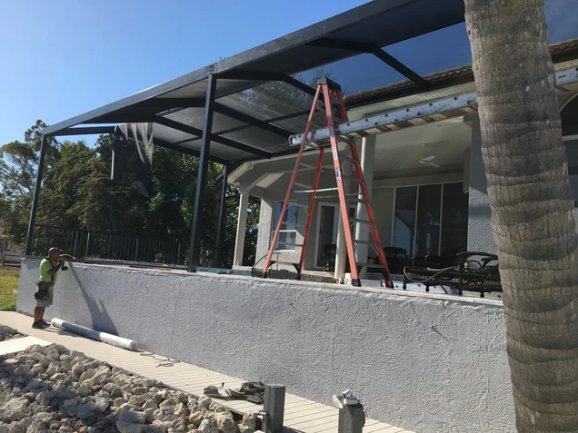 AlumiPRO's construction team working on a custom screen enclosure in Naples, Florida.